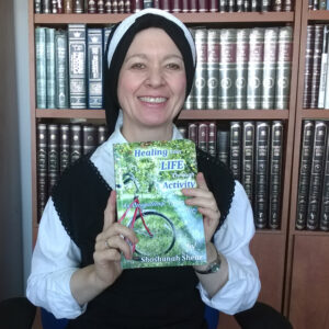 Shoshanah with Proof Copy of her book "Healing Your Life Through Activity"
