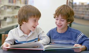 Boys reading together