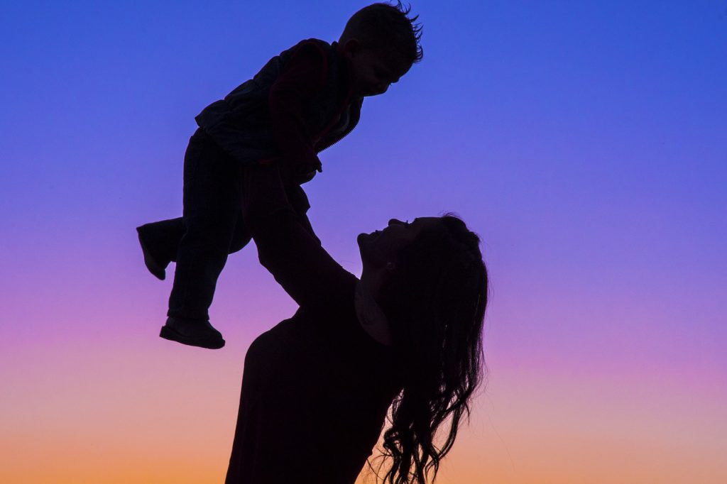 Silhouette of a woman lifting her baby representing hope for women over 40