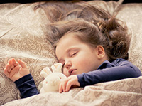 Child sleeping with teddybear