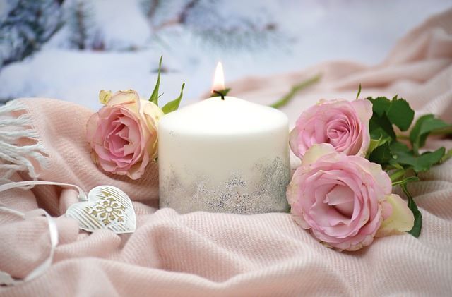 candle with pink roses for relaxing scene