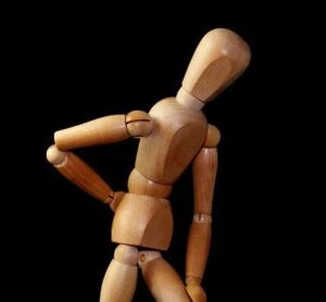 Wooden doll with hand on back